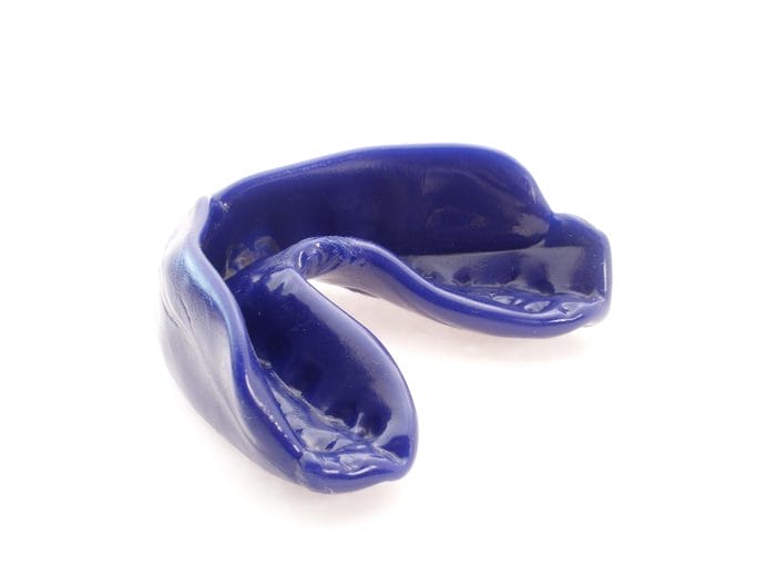 one blue mouthguard isolated on white background. Ivy Lane Dentistry offers various mouth guard options for sports or dental health support in San Antonio, TX.